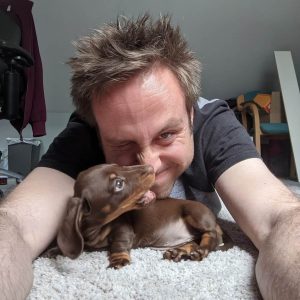 Me and my chocolate brown Miniature Dachshund, Pippin, biting my nose!